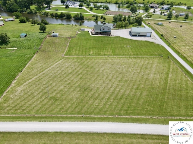 drone / aerial view with a water view and a rural view