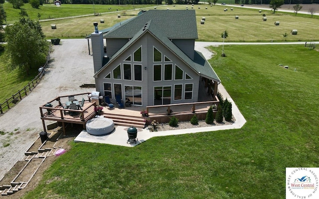 rear view of house featuring a deck and a rural view