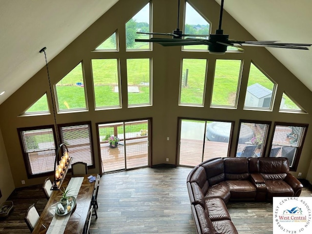 living room featuring high vaulted ceiling, a ceiling fan, a healthy amount of sunlight, and wood finished floors