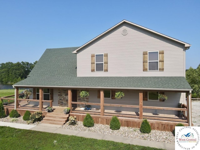 view of front facade with covered porch and roof with shingles