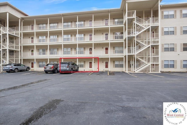 view of property featuring uncovered parking