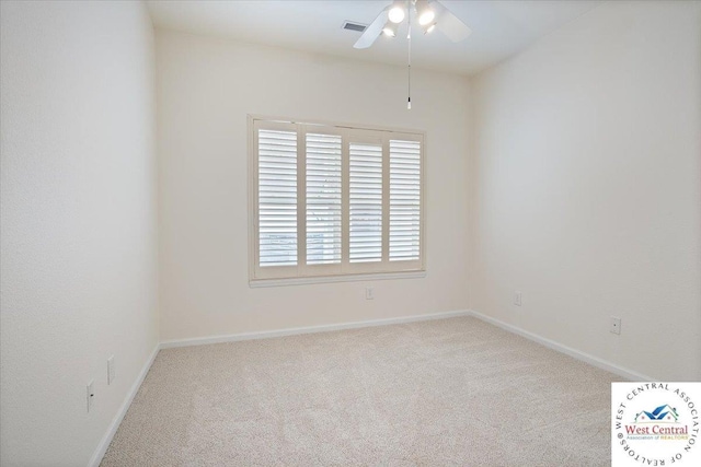 empty room with visible vents, carpet floors, baseboards, and ceiling fan