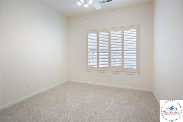 carpeted empty room with visible vents, baseboards, and ceiling fan