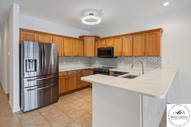 kitchen with a sink, black electric range oven, brown cabinetry, and stainless steel fridge with ice dispenser