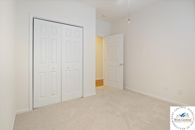 unfurnished bedroom with a closet, baseboards, and carpet