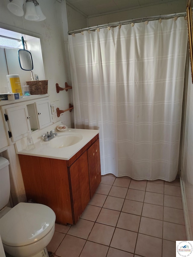 full bath with curtained shower, vanity, toilet, and tile patterned floors