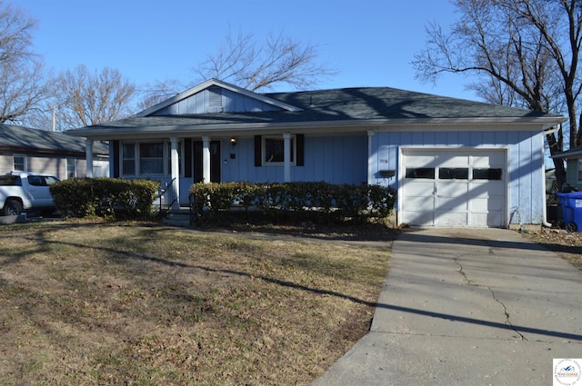 ranch-style home featuring driveway, a front yard, and a garage