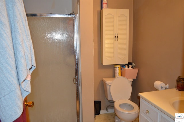 bathroom with vanity, toilet, and a stall shower