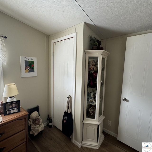33039 Hilty Ave, Warsaw, MO 65355 - bedroom featuring a textured ceiling, baseboards, and dark wood-type flooring