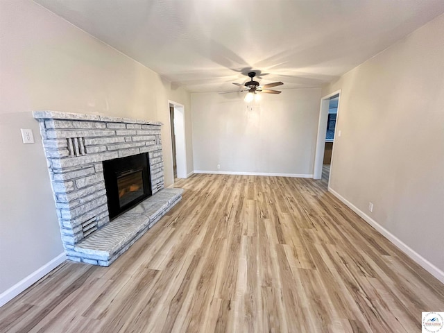 unfurnished living room featuring baseboards, wood finished floors, and ceiling fan