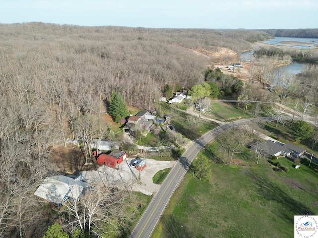 aerial view with a water view and a forest view