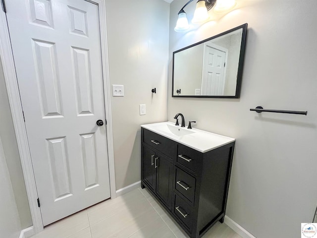 bathroom featuring tile patterned flooring, vanity, and baseboards