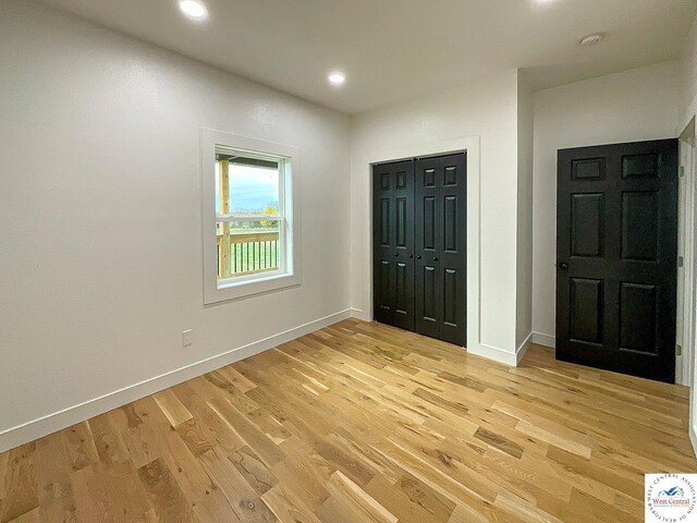17788 Main Rd, Sedalia, MO 65301 - unfurnished bedroom featuring light wood-style floors, baseboards, recessed lighting, and a closet