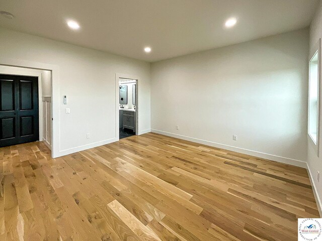 17788 Main Rd, Sedalia, MO 65301 - unfurnished bedroom featuring light wood-style floors, ensuite bathroom, baseboards, and recessed lighting
