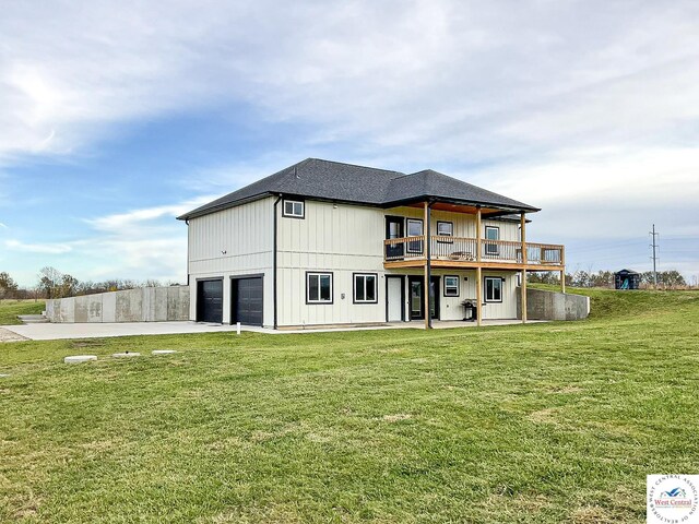 17788 Main Rd, Sedalia, MO 65301 - rear view of house featuring a garage, a yard, board and batten siding, a deck, and concrete driveway