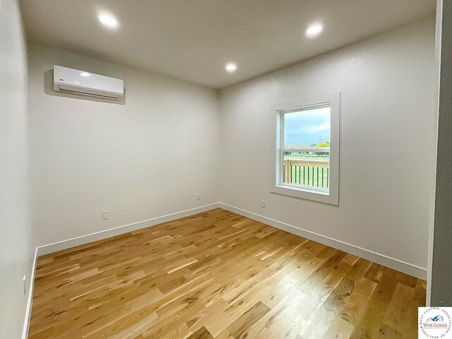 17788 Main Rd, Sedalia, MO 65301 - unfurnished room featuring a wall mounted AC, light wood finished floors, baseboards, and recessed lighting