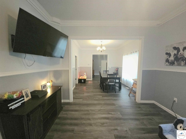 1012 E 7th St, Sedalia, MO 65301 - hall featuring dark wood finished floors, a chandelier, ornamental molding, and baseboards