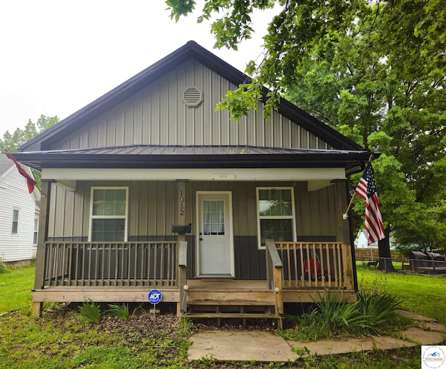 1012 E 7th St, Sedalia, MO 65301 - bungalow-style house featuring a porch and board and batten siding