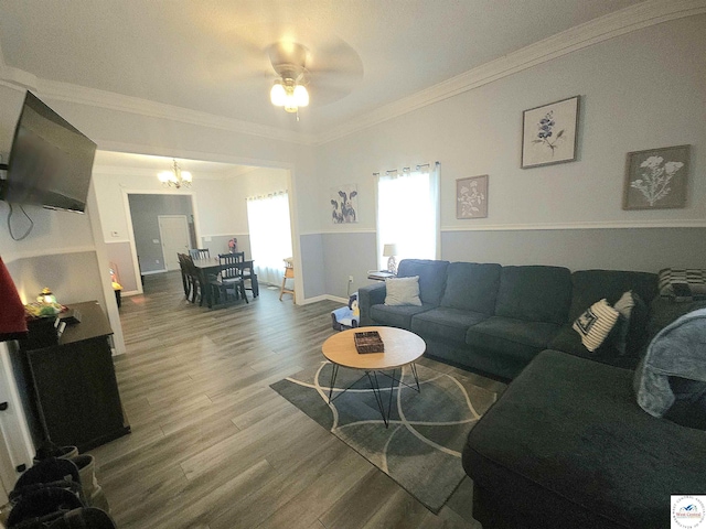 1012 E 7th St, Sedalia, MO 65301 - living area featuring wood finished floors, a chandelier, ceiling fan, crown molding, and baseboards