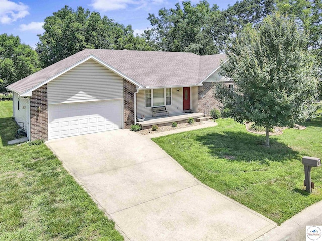 56 NW 247th Rd, Clinton, MO 64735 - single story home featuring a porch, a garage, brick siding, driveway, and a front lawn