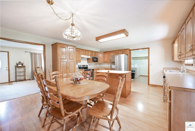 56 NW 247th Rd, Clinton, MO 64735 - dining space with light wood-style floors and a chandelier
