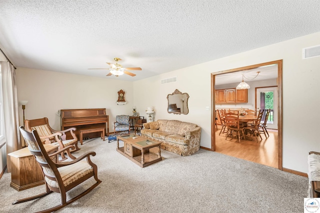 56 NW 247th Rd, Clinton, MO 64735 - living area featuring light colored carpet, a textured ceiling, and a ceiling fan