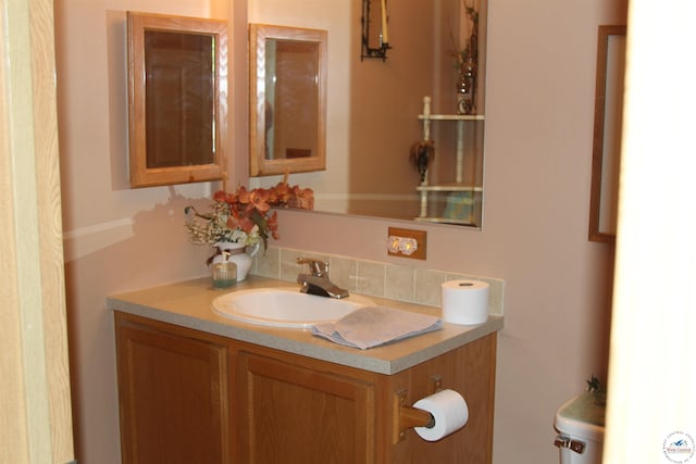half bathroom with vanity and decorative backsplash