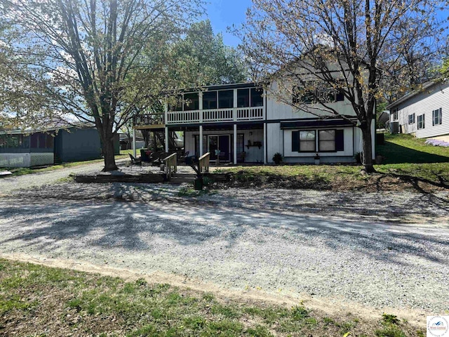view of front facade with a sunroom and a patio area