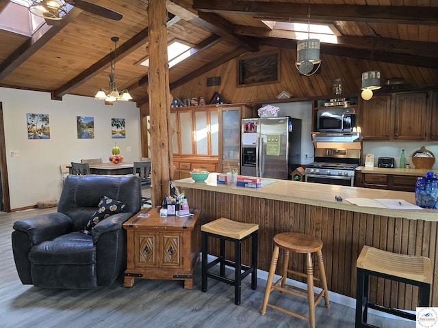 17509 Snowcap Loop, Warsaw, MO 65355 - kitchen featuring wood ceiling, wood finished floors, light countertops, appliances with stainless steel finishes, and vaulted ceiling with beams