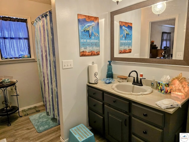 full bathroom with vanity, curtained shower, and wood finished floors