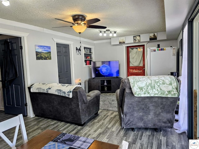 living area featuring track lighting, a textured ceiling, ceiling fan, and wood finished floors