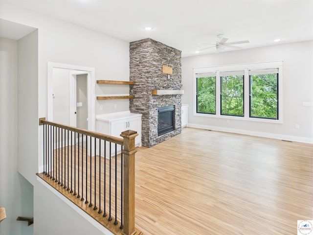 1248 Rich Blvd, Warrensburg, MO 64093 - unfurnished living room with a ceiling fan, light wood-type flooring, a stone fireplace, and recessed lighting