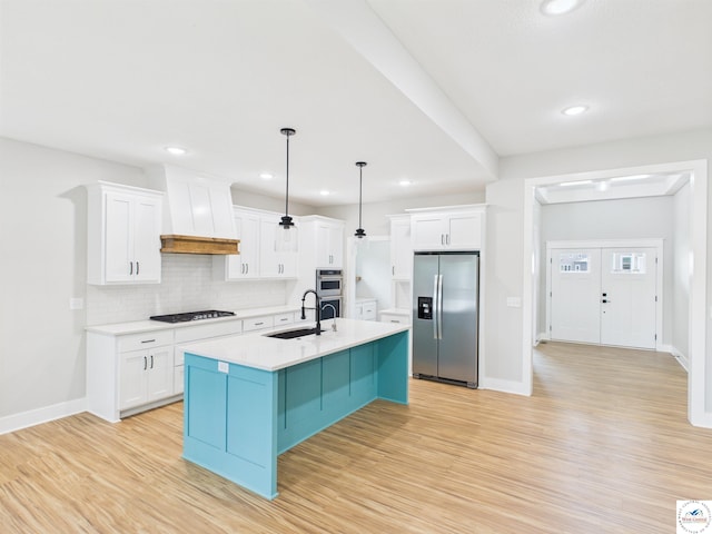 1248 Rich Blvd, Warrensburg, MO 64093 - kitchen featuring stainless steel appliances, premium range hood, decorative backsplash, light wood-style flooring, and white cabinets