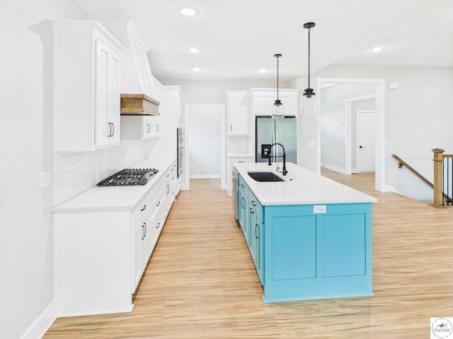 1248 Rich Blvd, Warrensburg, MO 64093 - kitchen with stainless steel appliances, blue cabinets, light wood-type flooring, and recessed lighting