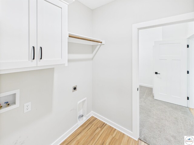 1248 Rich Blvd, Warrensburg, MO 64093 - laundry area featuring cabinet space, hookup for an electric dryer, hookup for a washing machine, and light wood-style flooring