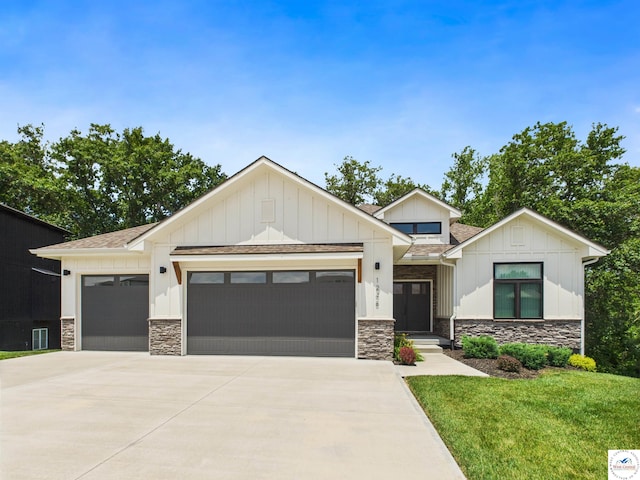 1248 Rich Blvd, Warrensburg, MO 64093 - modern farmhouse featuring an attached garage, concrete driveway, stone siding, and board and batten siding