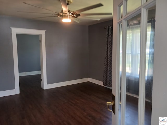 501 S Oak St, Versailles, MO 65084 - unfurnished room with a ceiling fan and dark wood finished floors