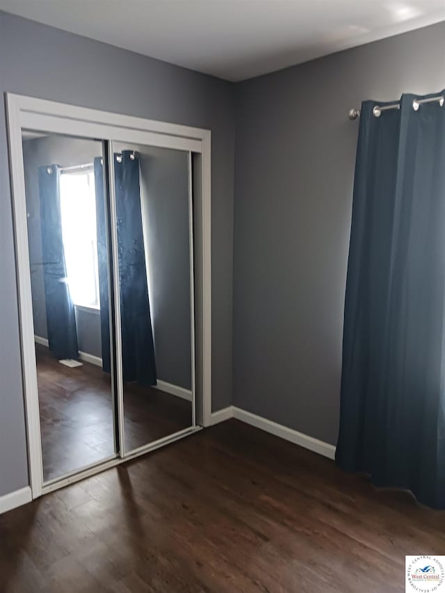 501 S Oak St, Versailles, MO 65084 - unfurnished bedroom with wood finished floors and a closet