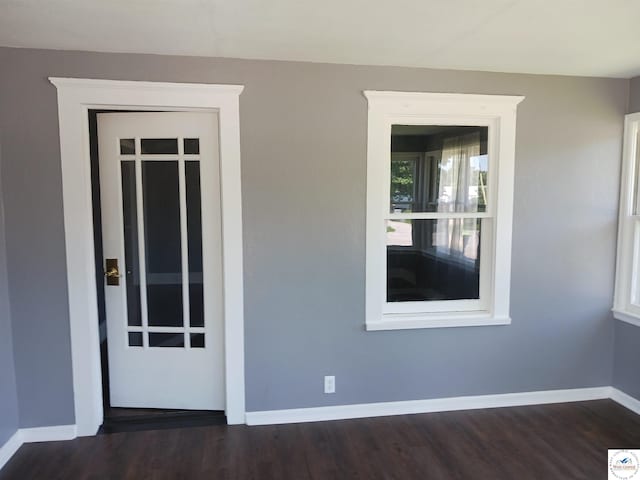 501 S Oak St, Versailles, MO 65084 - empty room featuring baseboards and dark wood-style flooring