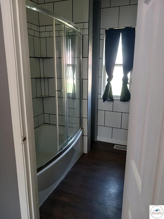 501 S Oak St, Versailles, MO 65084 - full bath with wood finished floors and shower / bath combination with glass door