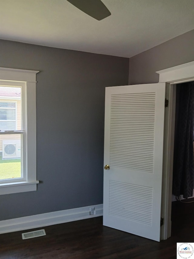 501 S Oak St, Versailles, MO 65084 - unfurnished bedroom with dark wood-style flooring and baseboards