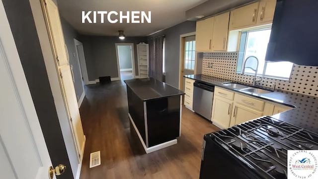 501 S Oak St, Versailles, MO 65084 - kitchen featuring stainless steel dishwasher, black range with gas cooktop, cream cabinets, backsplash, and dark wood-style flooring