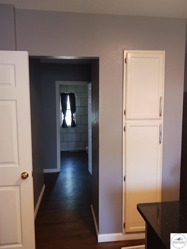 501 S Oak St, Versailles, MO 65084 - hallway with dark wood finished floors and baseboards