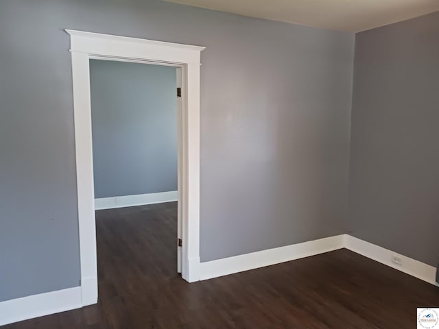 501 S Oak St, Versailles, MO 65084 - empty room featuring dark wood-type flooring and baseboards