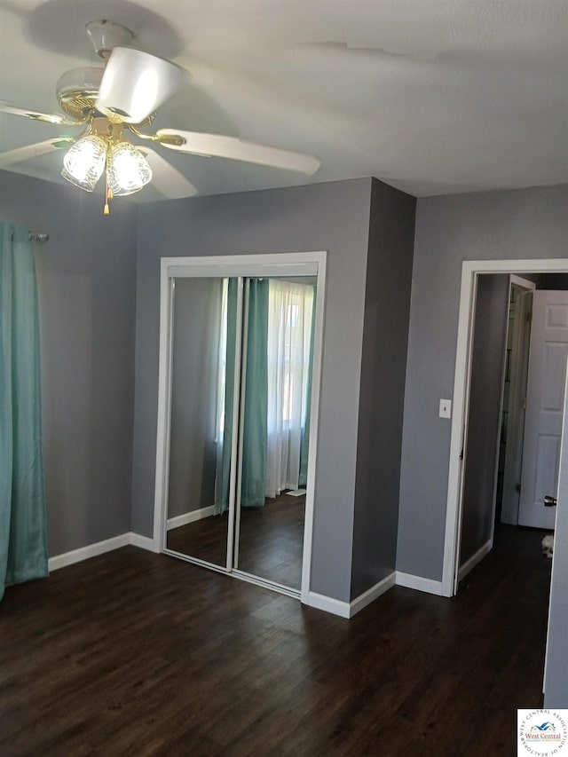 501 S Oak St, Versailles, MO 65084 - unfurnished bedroom with dark wood finished floors, a closet, and ceiling fan