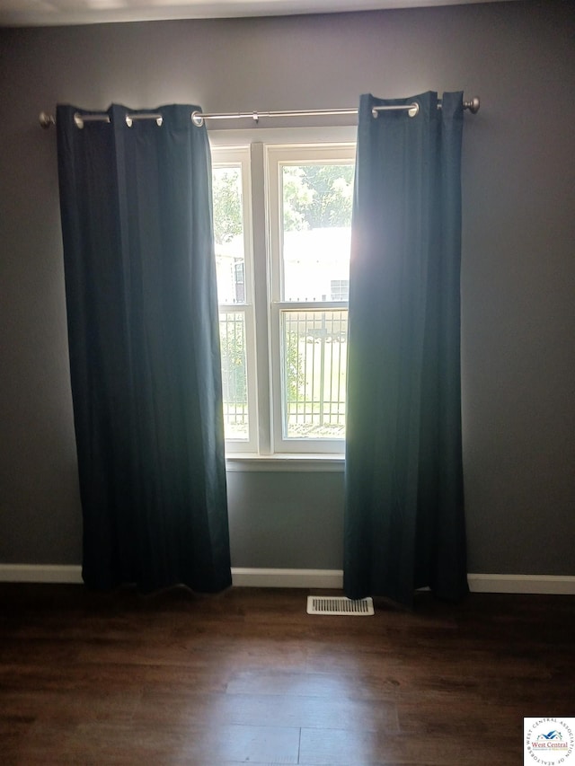 501 S Oak St, Versailles, MO 65084 - spare room featuring wood finished floors and baseboards