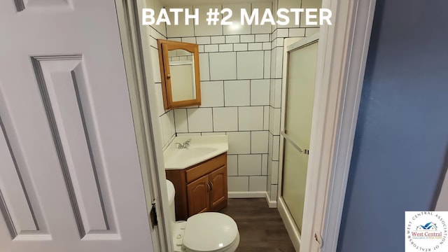 501 S Oak St, Versailles, MO 65084 - full bath with vanity, a shower with shower door, and wood finished floors
