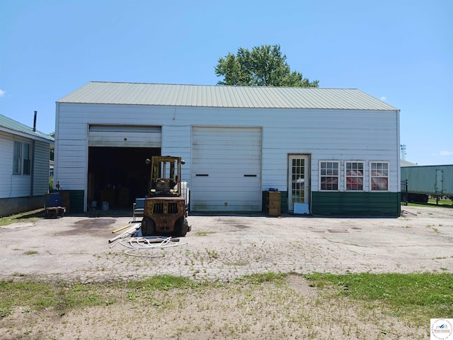 501 S Oak St, Versailles, MO 65084 - back of house with a detached garage and a metal roof