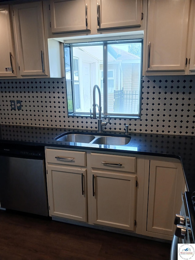 501 S Oak St, Versailles, MO 65084 - kitchen with stainless steel dishwasher, dark countertops, dark wood-style floors, and white cabinetry