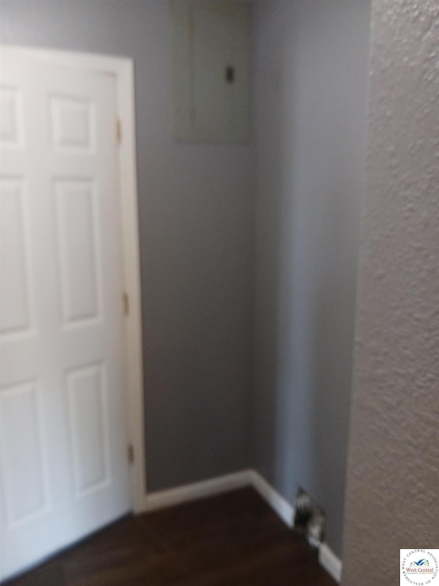 501 S Oak St, Versailles, MO 65084 - empty room with dark wood finished floors and a textured wall